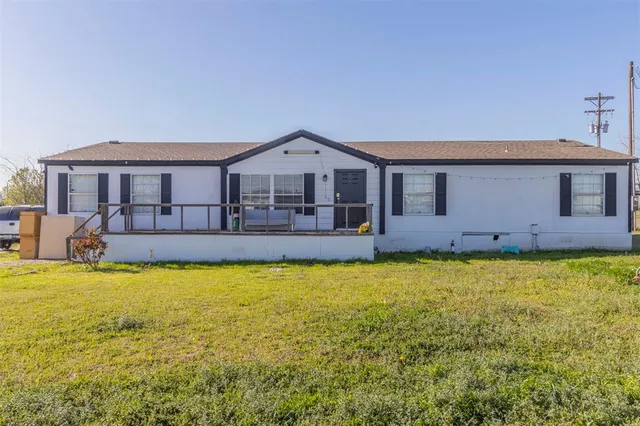 a view of a house with a swimming pool and a yard