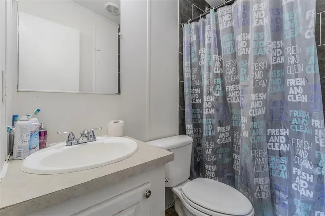 a view of a hallway and dining room with wooden floor