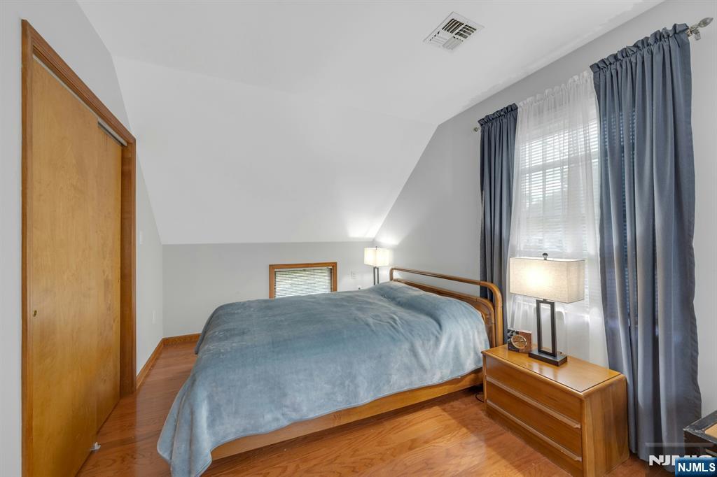 24 Cambridge Road Tenafly, NJ 07670 - Photo 23 of 31 a bedroom with a bed and lamp with window
