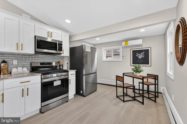 a kitchen with stainless steel appliances a stove microwave and refrigerator
