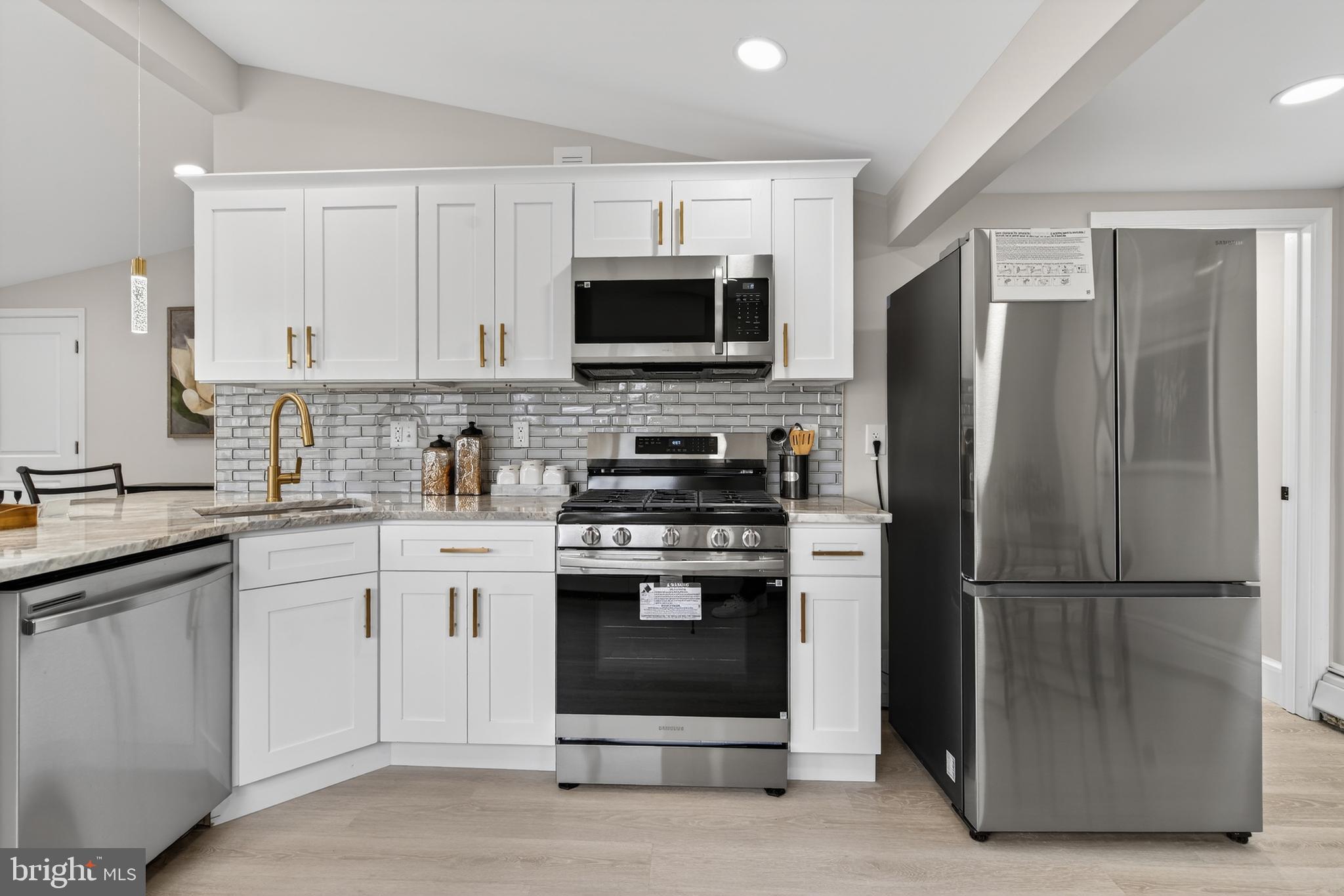 226 Ruth Avenue Maple Shade, NJ 08052 - Photo 15 of 32 a kitchen with stainless steel appliances granite countertop a refrigerator stove a sink and a microwave