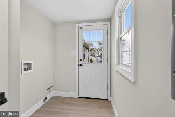 a view of a hallway with wooden floor and windows