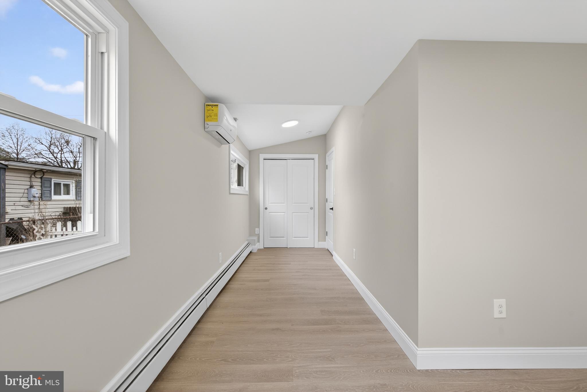 226 Ruth Avenue Maple Shade, NJ 08052 - Photo 24 of 32 a view of a hallway with wooden floor and a bathroom