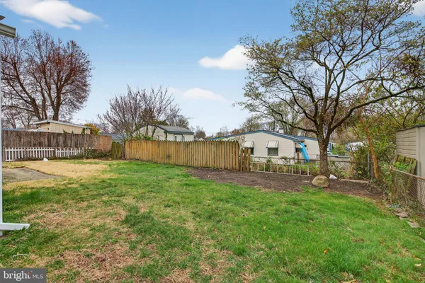 a view of a yard with a house in the background