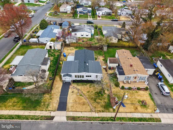 an aerial view of a house with a yard basket ball court and outdoor seating