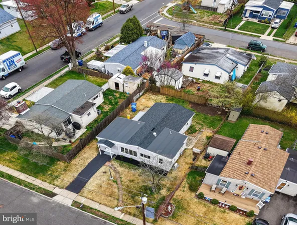 an aerial view of a house with a garden and trees