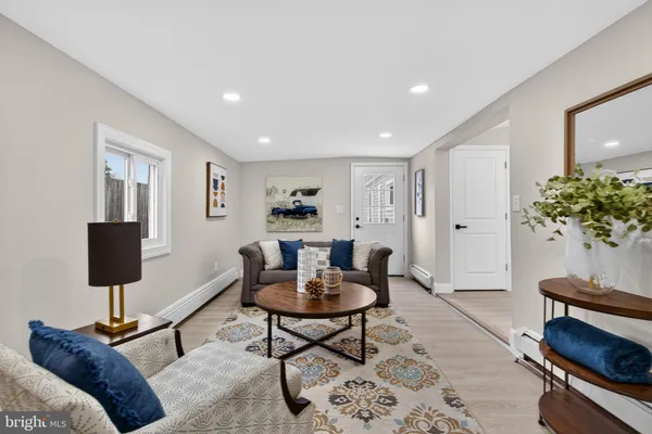 a living room with furniture and a potted plant