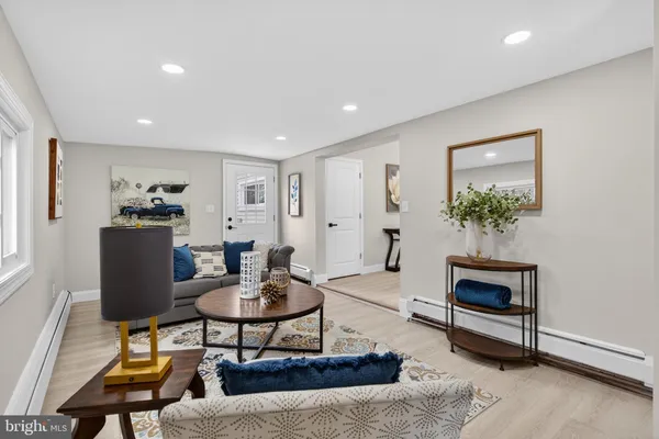 a living room with furniture and a potted plant