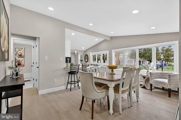 a dining room with furniture and a floor to ceiling window