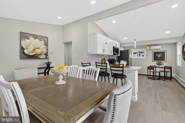 a dining room with furniture and view kitchen
