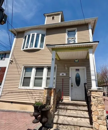 a front view of a house with many windows