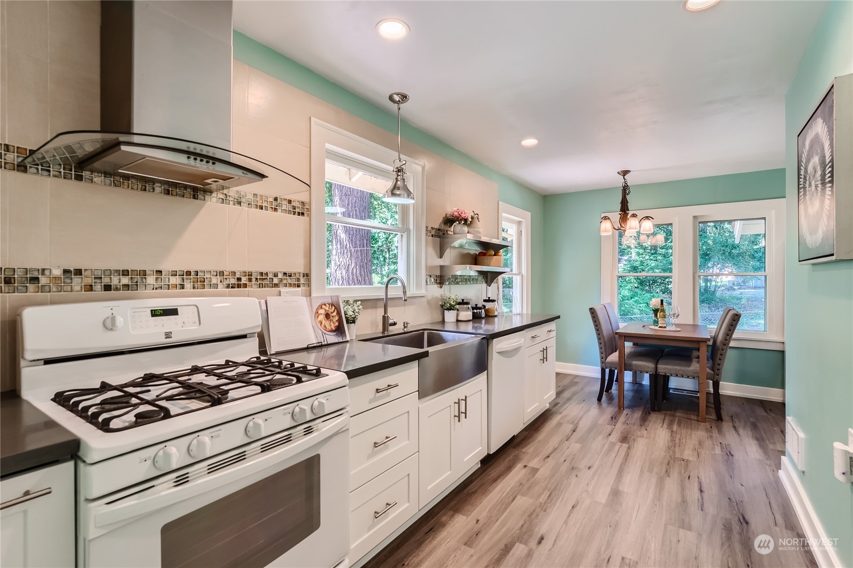 18045 120th Avenue Southeast Renton, WA 98058 - Photo 6 of 23 a kitchen with a stove a sink and wooden floor