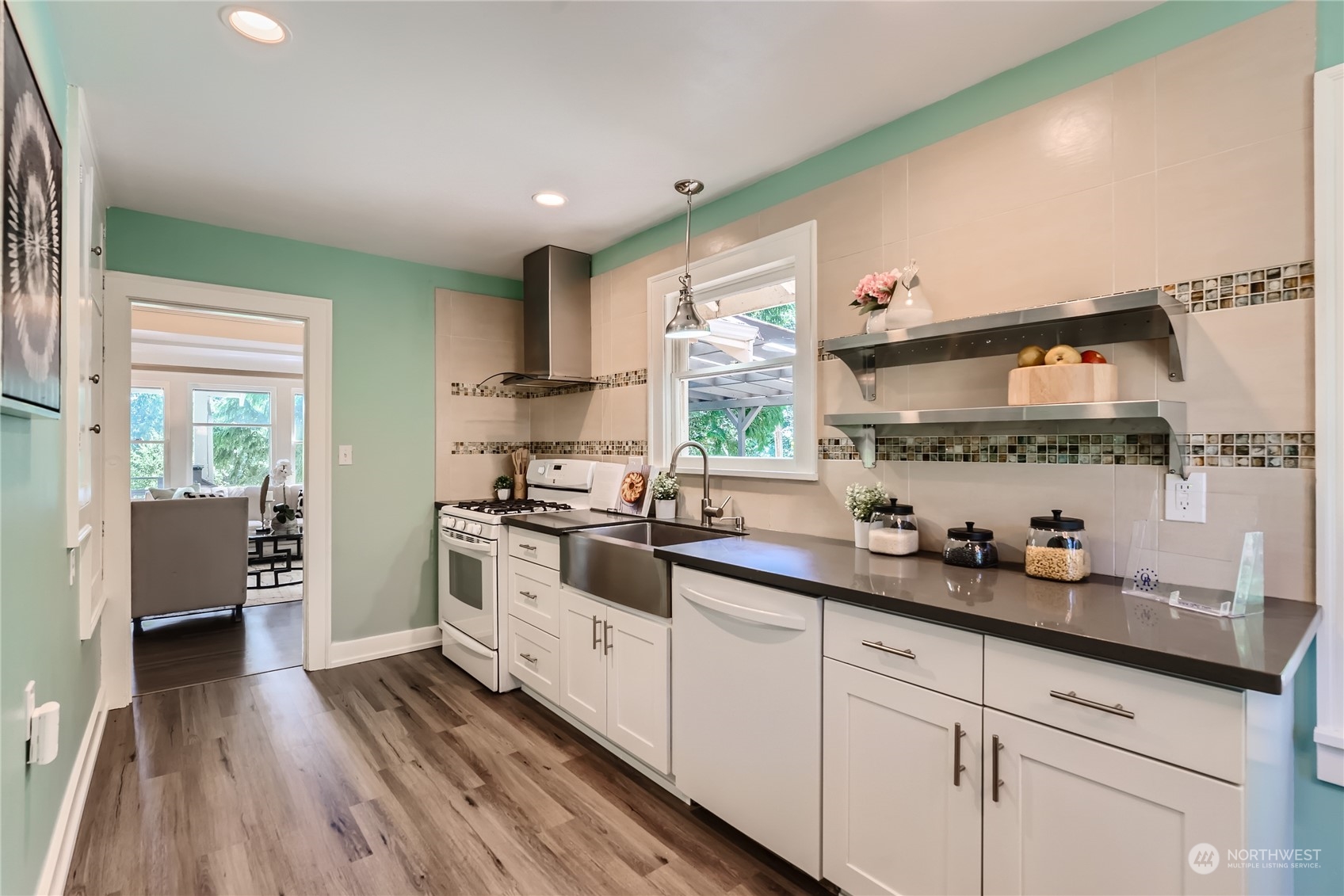 18045 120th Avenue Southeast Renton, WA 98058 - Photo 7 of 23 a kitchen with a sink stove and cabinets