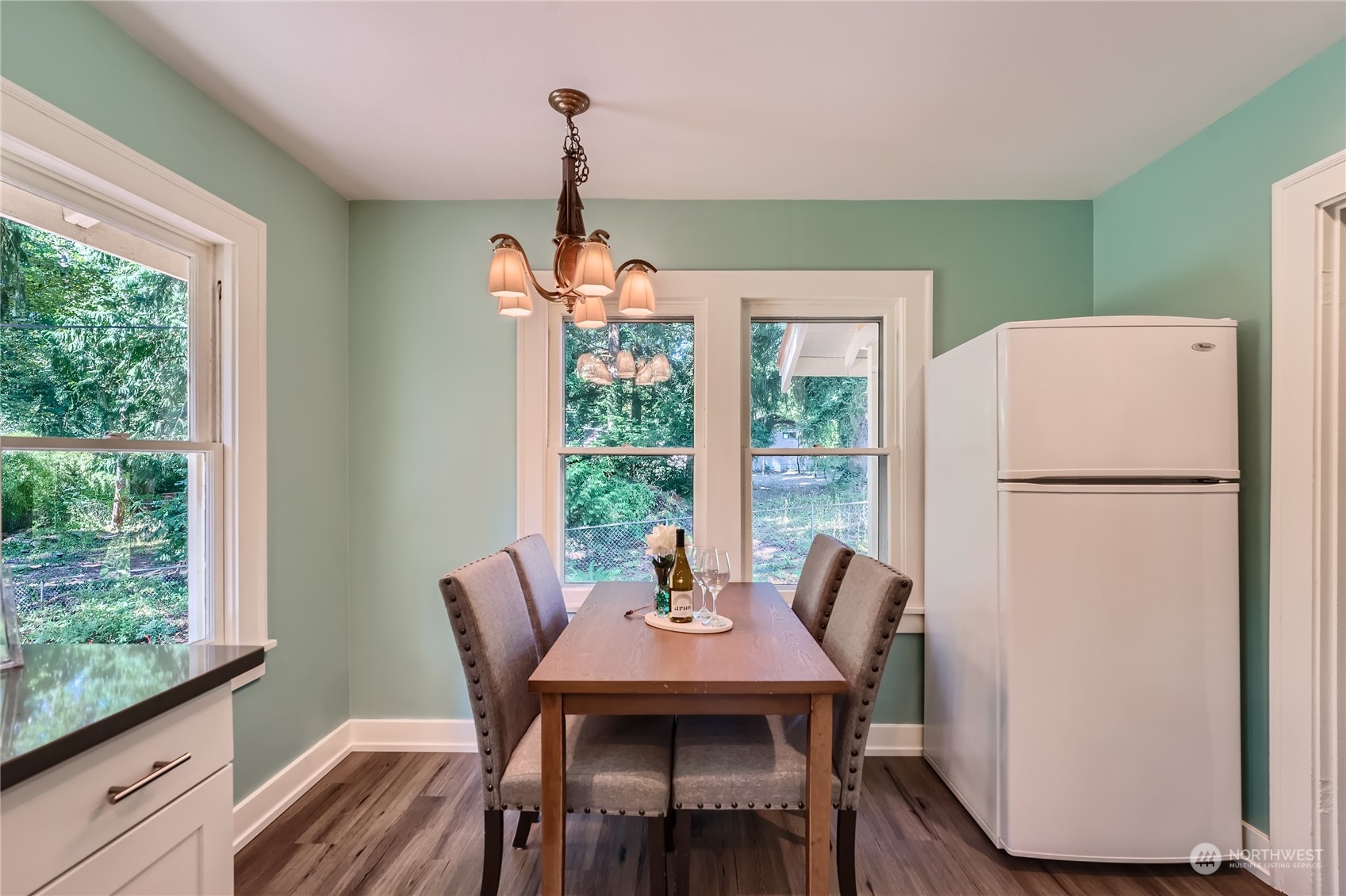 18045 120th Avenue Southeast Renton, WA 98058 - Photo 9 of 23 a dining room with furniture a chandelier and wooden floor