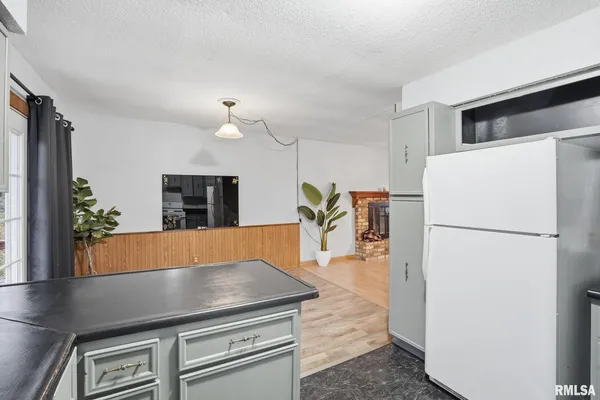 a kitchen with refrigerator and stove