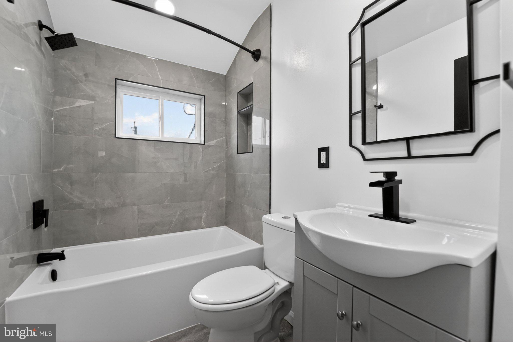 643 South Wickham Road Baltimore, MD 21229 - Photo 26 of 32 Sleek modern bathroom with natural light.