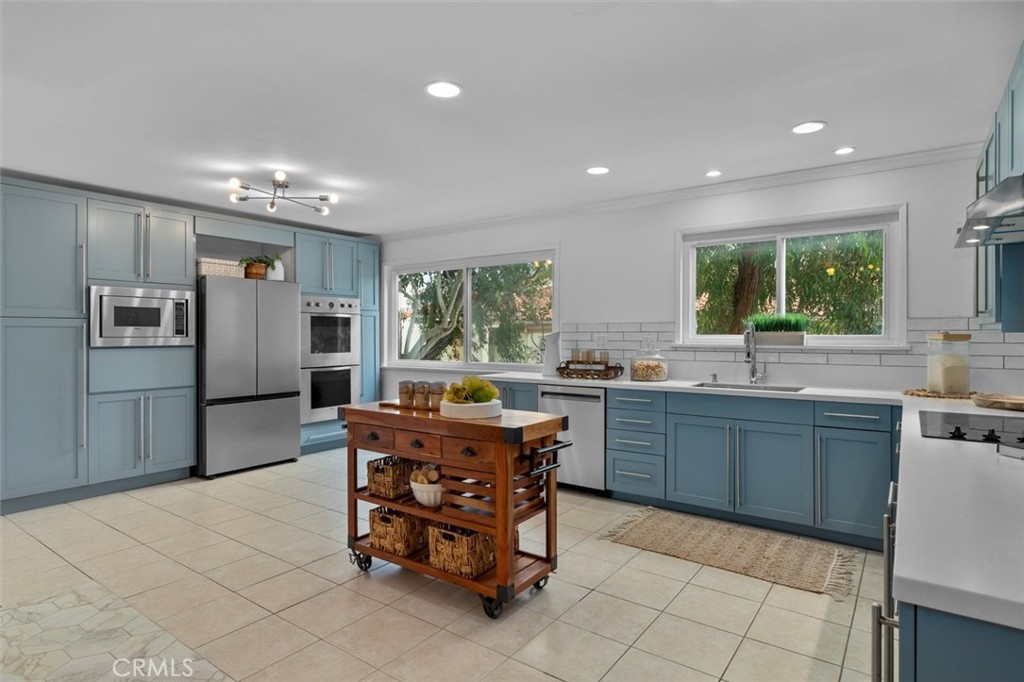 1200 Opal Street, Unit 7 Redondo Beach, CA 90277 - Photo 13 of 40 a kitchen with stainless steel appliances granite countertop a refrigerator a sink a stove a dining table and chairs
