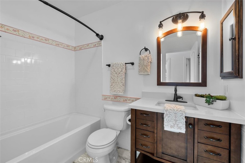 1200 Opal Street, Unit 7 Redondo Beach, CA 90277 - Photo 30 of 40 a bathroom with a granite countertop sink toilet and a mirror