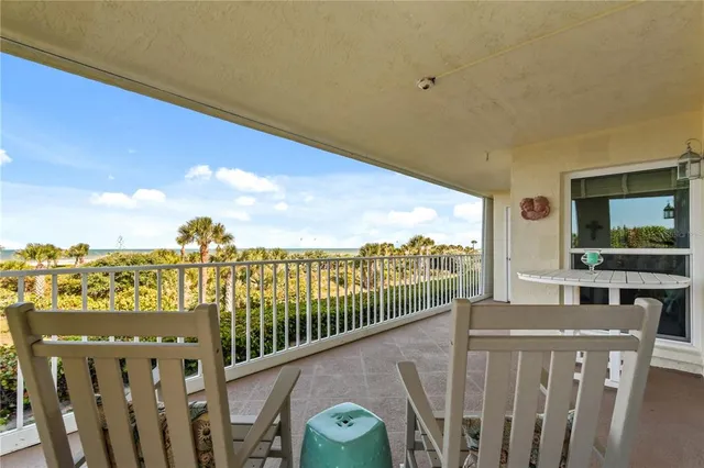a view of a balcony with furniture
