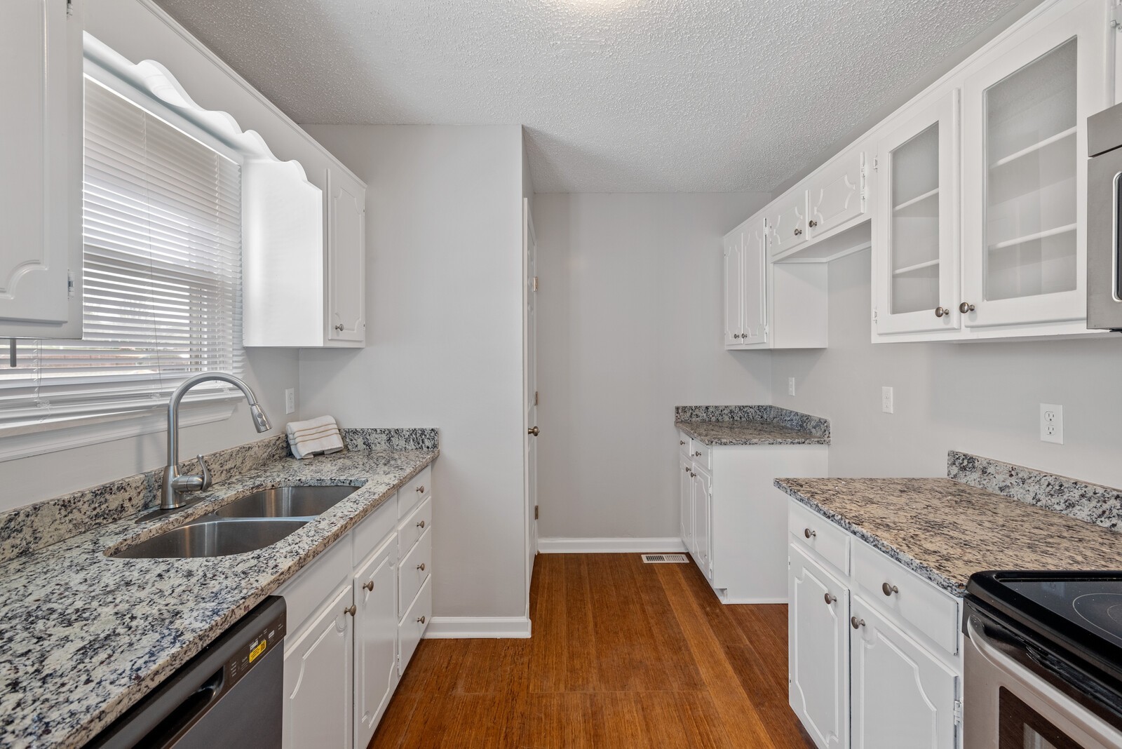 1617 Alsdale Road Mount Juliet, TN 37122 - Photo 12 of 34 a kitchen with granite countertop a sink stove and cabinets