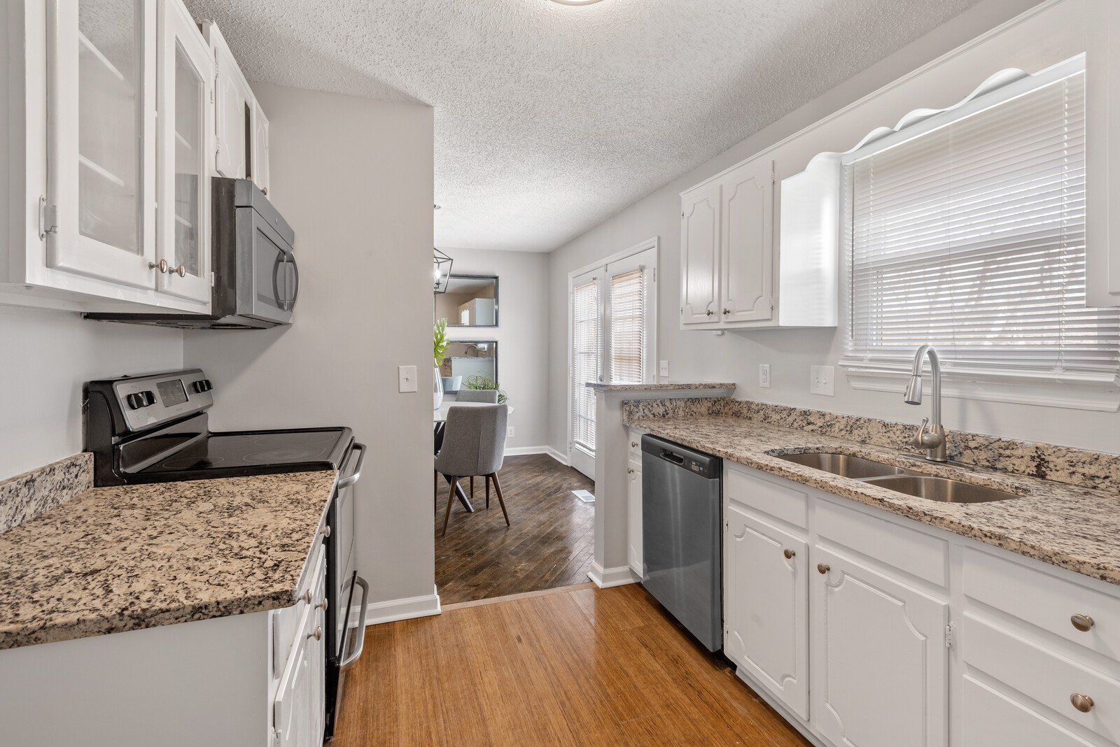 1617 Alsdale Road Mount Juliet, TN 37122 - Photo 10 of 34 a kitchen with stainless steel appliances granite countertop a sink stove and cabinets