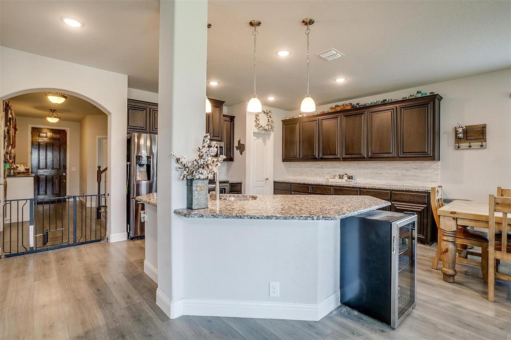 433 Joseph Lane Crowley, TX 76036 - Photo 12 of 40 a kitchen with stainless steel appliances granite countertop a sink a stove and a wooden floors