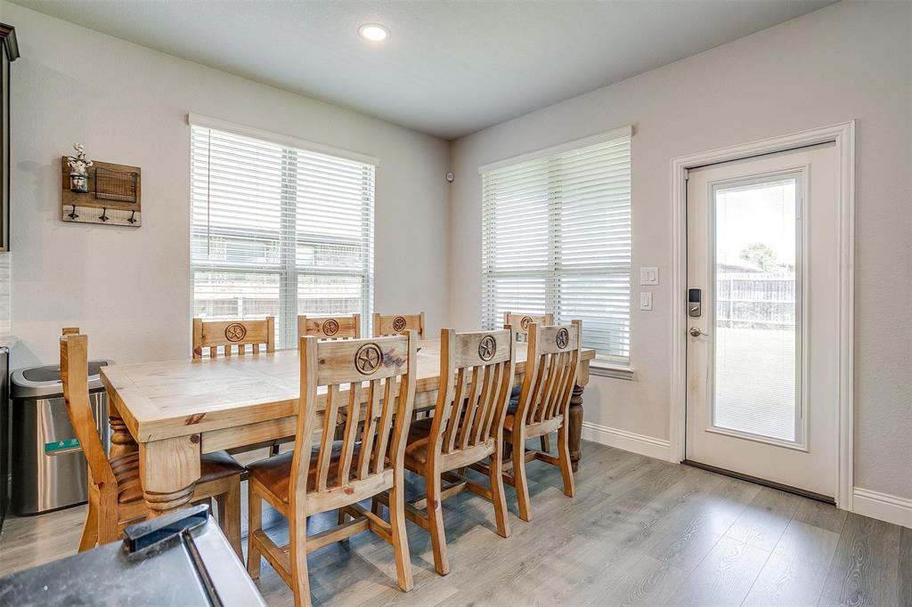 433 Joseph Lane Crowley, TX 76036 - Photo 14 of 40 a view of a dining room with furniture and wooden floor