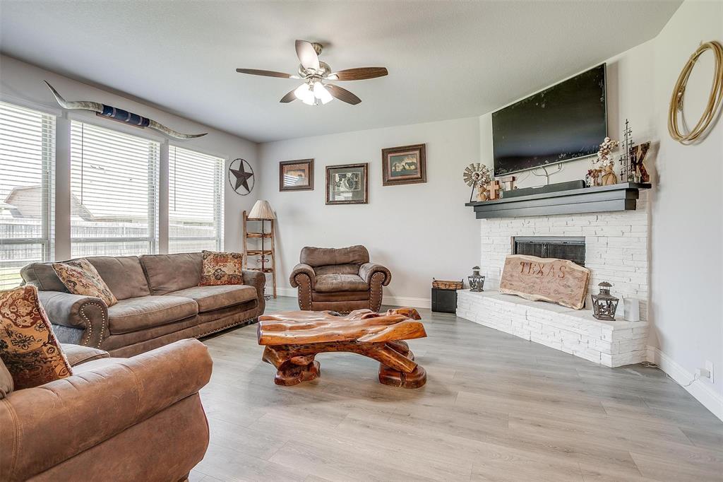 433 Joseph Lane Crowley, TX 76036 - Photo 16 of 40 a living room with furniture a fireplace and a flat screen tv
