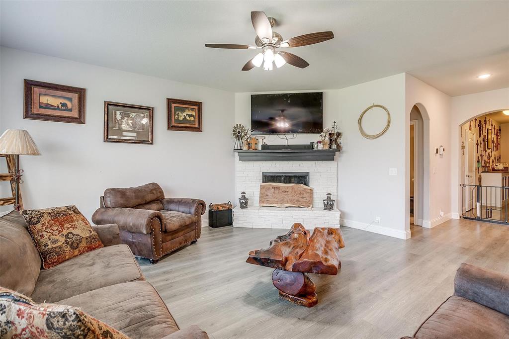 433 Joseph Lane Crowley, TX 76036 - Photo 18 of 40 a living room with furniture a flat screen tv and a fireplace
