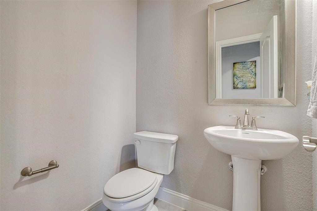 433 Joseph Lane Crowley, TX 76036 - Photo 22 of 40 a bathroom with a toilet sink and mirror