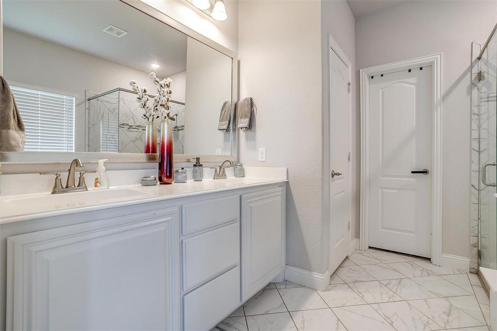 433 Joseph Lane Crowley, TX 76036 - Photo 24 of 40 a bathroom with a double vanity sink a mirror and shower