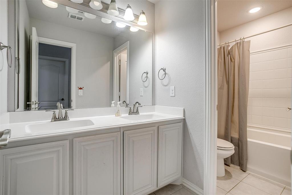 433 Joseph Lane Crowley, TX 76036 - Photo 32 of 40 a bathroom with a double vanity sink mirror and toilet