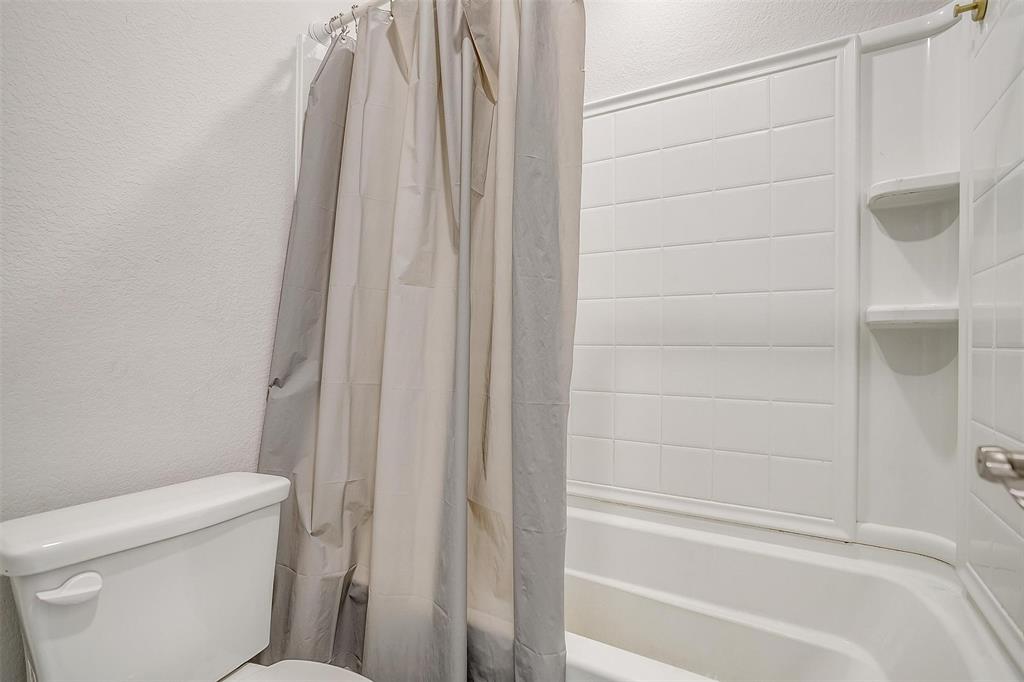 433 Joseph Lane Crowley, TX 76036 - Photo 33 of 40 a bathroom with a shower and a toilet