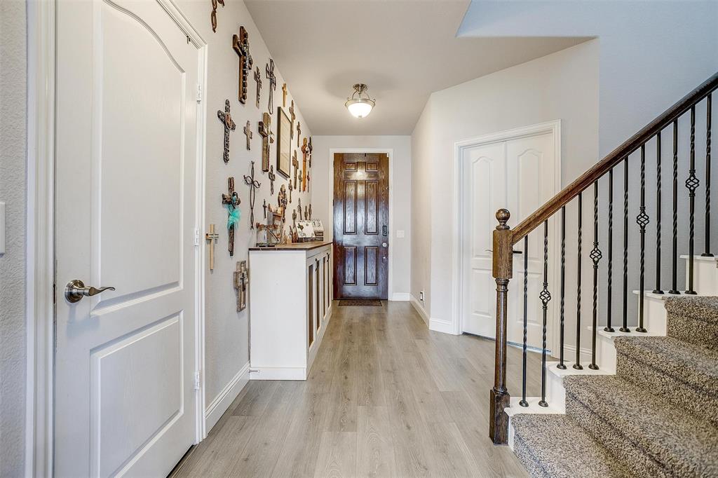 433 Joseph Lane Crowley, TX 76036 - Photo 5 of 40 a view of a hallway view with wooden floor and staircase