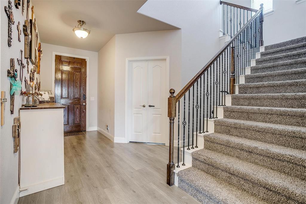 433 Joseph Lane Crowley, TX 76036 - Photo 6 of 40 a view of a hallway with wooden floor and staircase