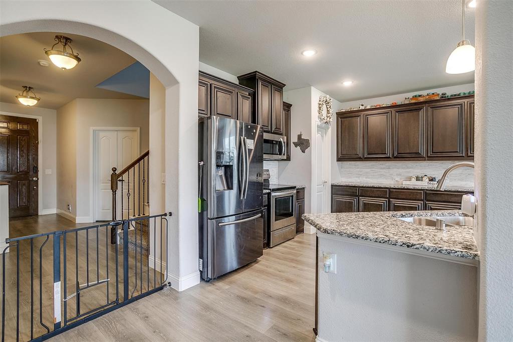 433 Joseph Lane Crowley, TX 76036 - Photo 7 of 40 a kitchen with stainless steel appliances granite countertop a refrigerator a stove and a sink
