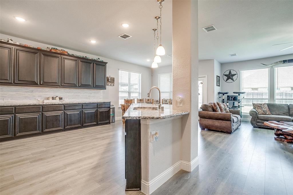 433 Joseph Lane Crowley, TX 76036 - Photo 8 of 40 a kitchen with stainless steel appliances kitchen island granite countertop a stove a sink and a refrigerator