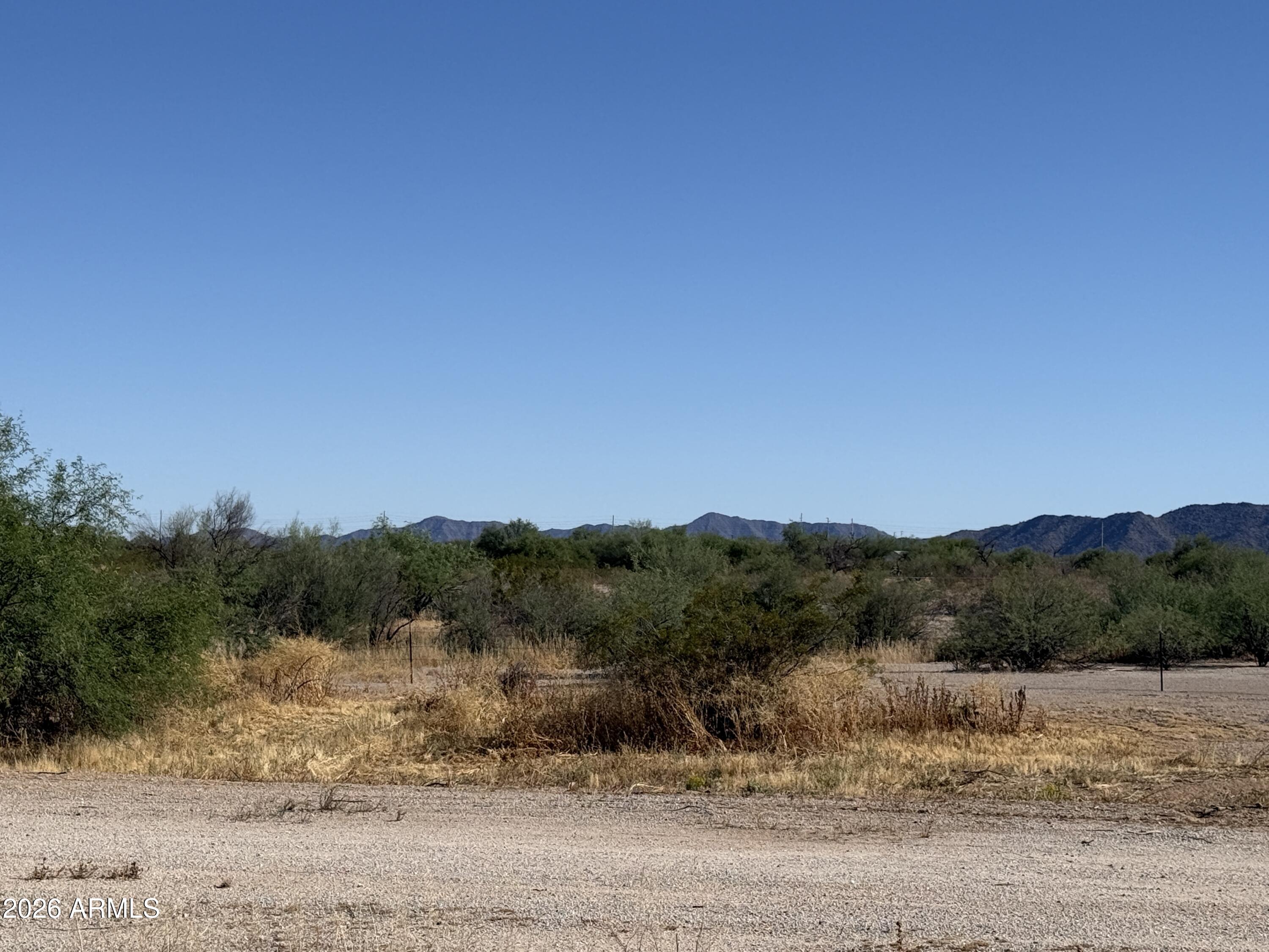 17403 West Baseline Road Buckeye, AZ 85326 - Photo 1 of 3 a view of a lake with mountains in the background