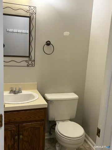 a bathroom with a sink a toilet and a mirror