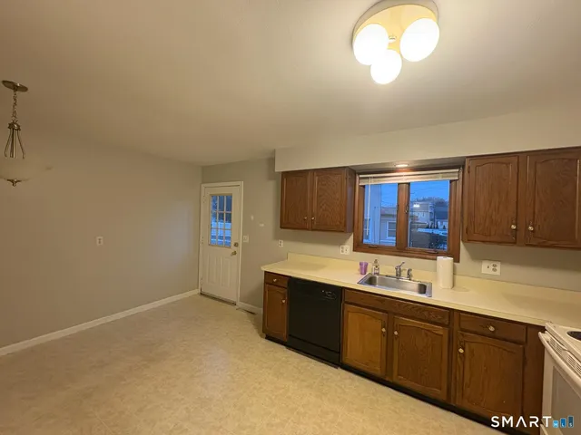a kitchen with sink cabinets and window