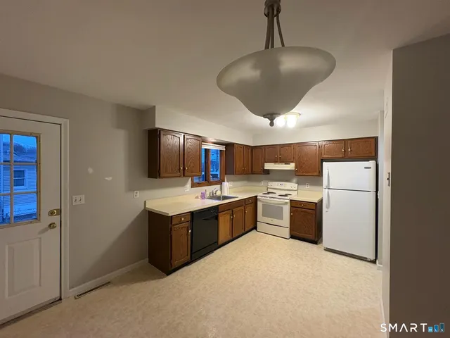 a kitchen with a stove sink and white cabinets