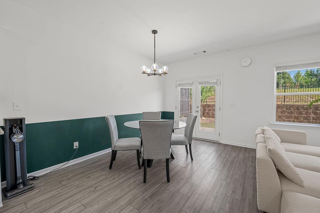 922 Edwin Lane Sugar Hill, GA 30518 - Photo 18 of 43 a dining room with furniture a window and wooden floor