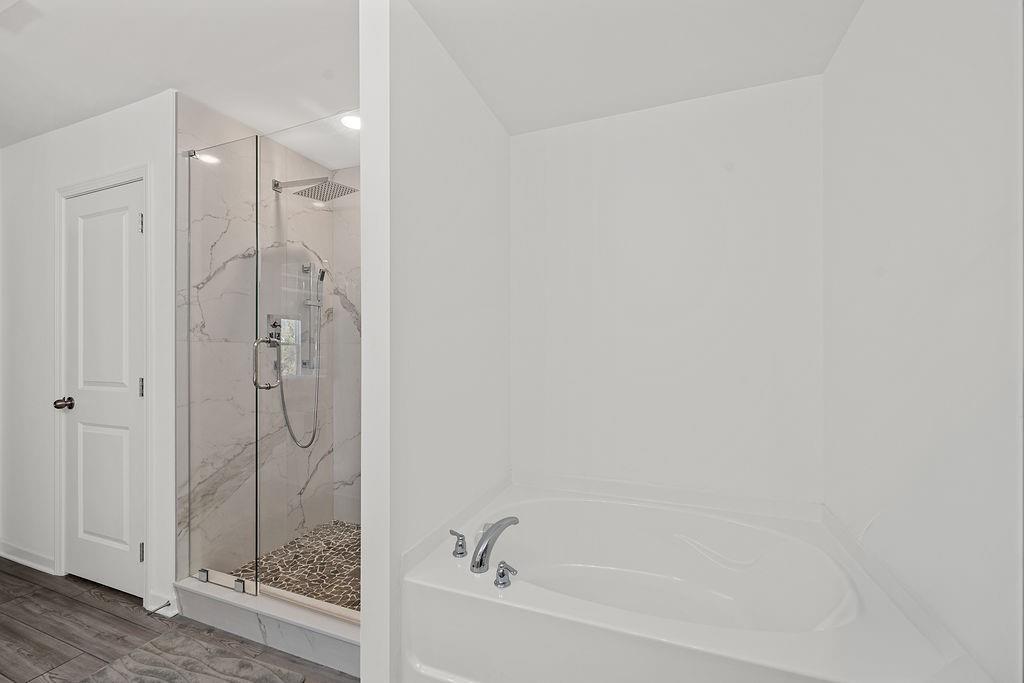 922 Edwin Lane Sugar Hill, GA 30518 - Photo 29 of 43 a bathroom with a bathtub and shower