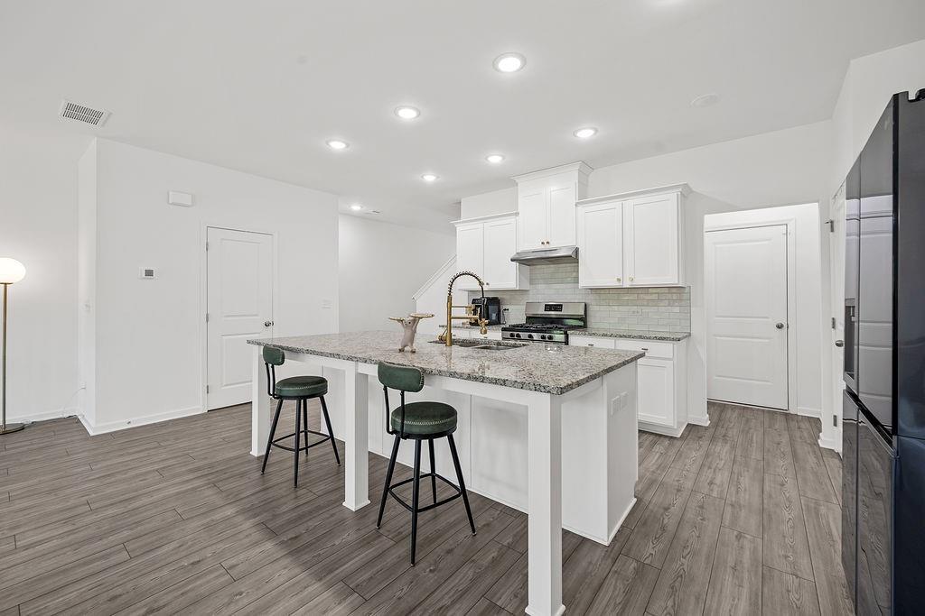 922 Edwin Lane Sugar Hill, GA 30518 - Photo 10 of 43 a kitchen with stainless steel appliances granite countertop a stove a sink a refrigerator and a microwave