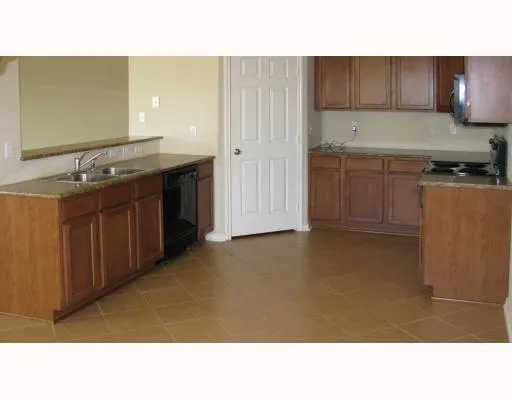 a kitchen with kitchen island sink and stove