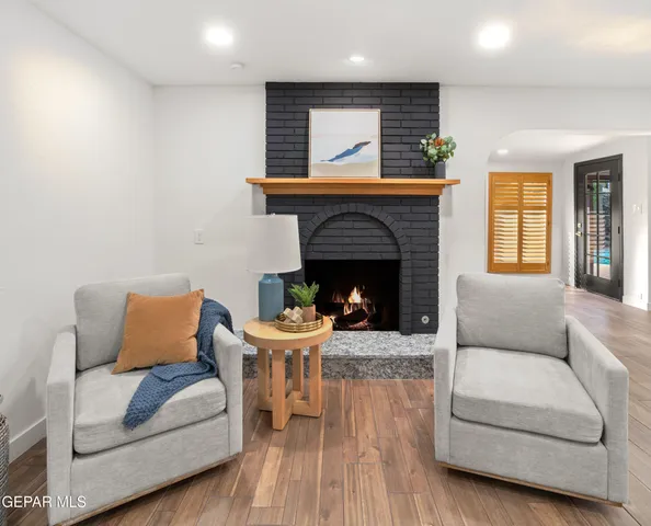 a dining room with furniture and a potted plant
