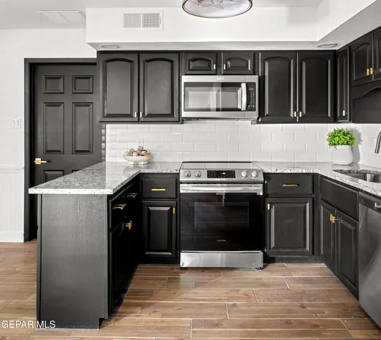 a kitchen with a refrigerator and a microwave