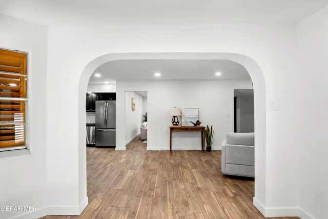 a living room with furniture and a ceiling fan