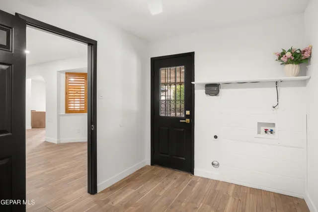 a spacious bathroom with a granite countertop sink a toilet a mirror and shower