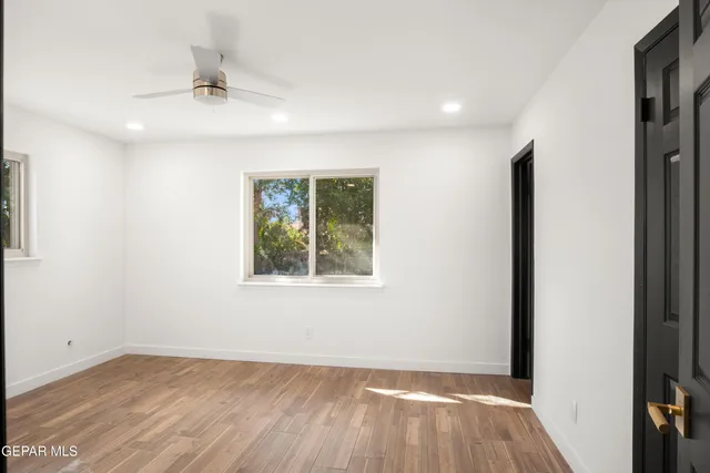 an empty room with a painting on the wall